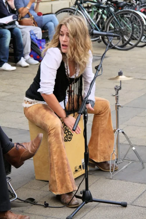 The Ultimate Guide to Musical Instruments That Start With C 1 Heidi Joubert of Fernando's Kitchen playing a Cajon.